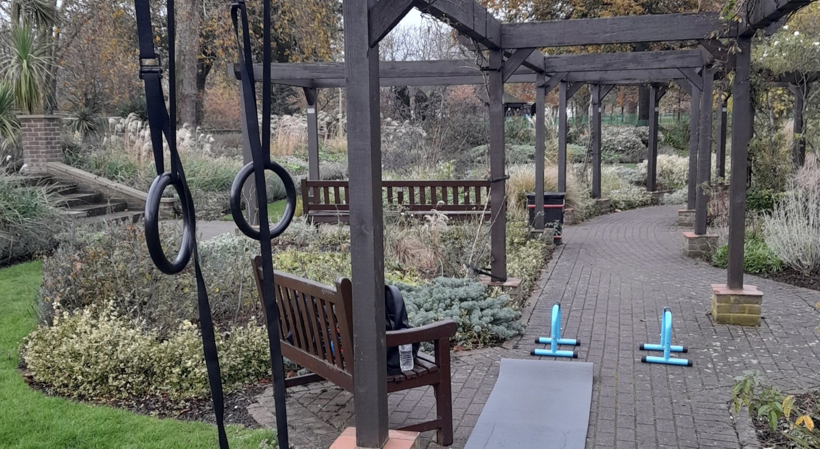 Victorian gardens at West Ham Park featuring outdoor gym resistance machines and open green space for workouts